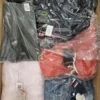 The photo shows a package with clothing in the category AJS.
