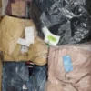 The photo shows a package with clothing in the category AJS.