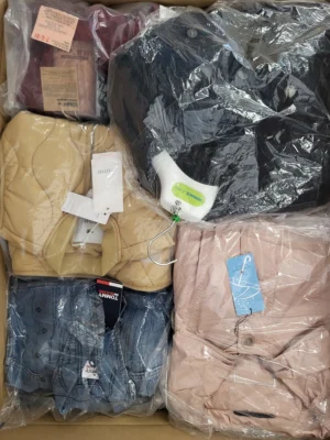 The photo shows a package with clothing in the category AJS.