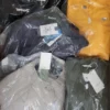The photo shows a package with clothing in the category AJS.