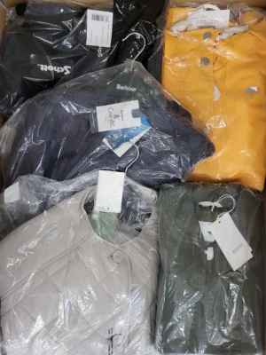 The photo shows a package with clothing in the category AJS.