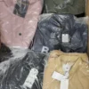The photo shows a package with clothing in the category AJS.