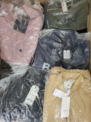 The photo shows a package with clothing in the category AJS.
