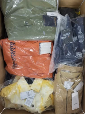 The photo shows a package with clothing in the category AJS.