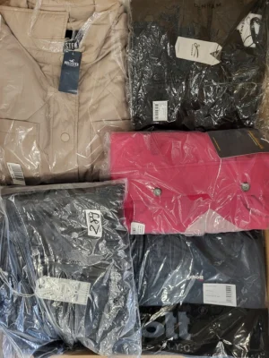 The photo shows a package with clothing in the category AJS.