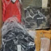 The photo shows a package with clothing in the category AJS.