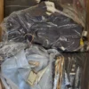 The photo shows a package with clothing in the category AJS.