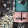 The photo shows a package with clothing in the category AJS.