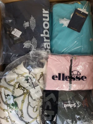The photo shows a package with clothing in the category AJS.