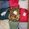 The photo shows a package with clothing in the category TSC.