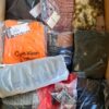 The photo shows a package with clothing in the category AM.