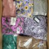 The photo shows a package with clothing in the category AR.