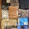 The photo shows a package with clothing in the category AR.