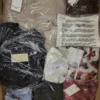 The photo shows a package with clothing in the category AW.