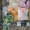 The photo shows a package with clothing in the category AW.