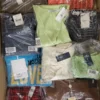 The photo shows a package with clothing in the category AW.