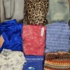 The photo shows a package with clothing in the category SN.