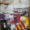 The photo shows a package with clothing in the category AW.