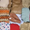 The photo shows a package with clothing in the category SN.