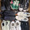 The photo shows a package with footwear in the category SH.