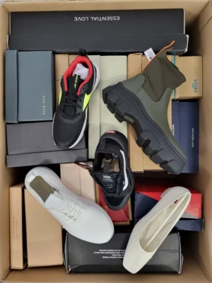 The photo shows a package with footwear in the category AS.