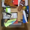 The photo shows a package with footwear in the category AS.