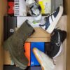 The photo shows a package with footwear in the category AS.