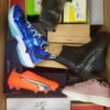 The photo shows a package with footwear in the category AS.