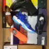 The photo shows a package with footwear in the category AS.
