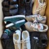 The photo shows a package with footwear in the category SH.