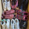 The photo shows a package with footwear in the category SH.