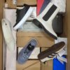 The photo shows a package with footwear in the category AS.