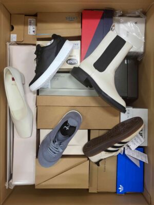 The photo shows a package with footwear in the category AS.