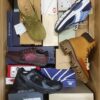 The photo shows a package with footwear in the category AS.