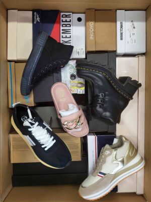 The photo shows a package with footwear in the category AS.