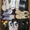 The photo shows a package with footwear in the category SH.