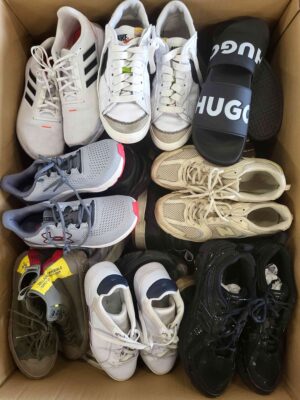 The photo shows a package with footwear in the category SH.