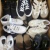 The photo shows a package with footwear in the category SH.