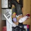 The photo shows a package with footwear in the category AS.