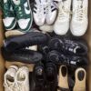 The photo shows a package with footwear in the category SH.