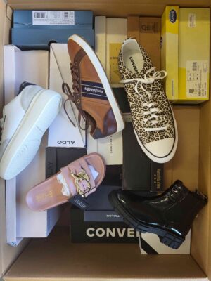 The photo shows a package with footwear in the category AS.