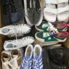 The photo shows a package with footwear in the category SH.