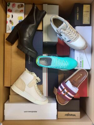 The photo shows a package with footwear in the category AS.