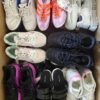 The photo shows a package with footwear in the category SH.