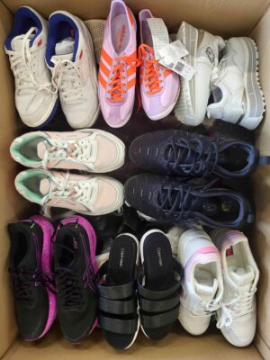 The photo shows a package with footwear in the category SH.