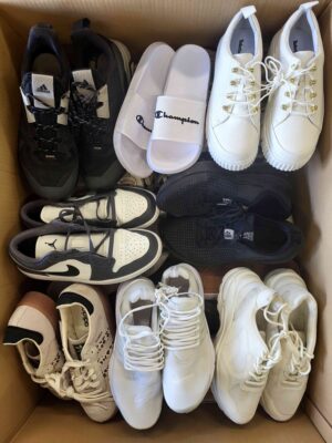 The photo shows a package with footwear in the category SH.
