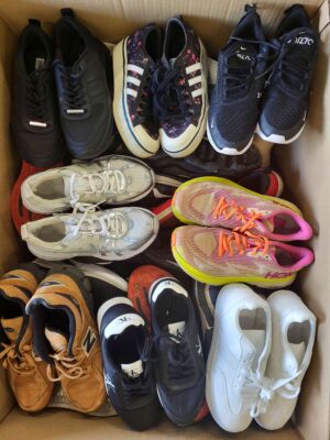 The photo shows a package with footwear in the category SH.