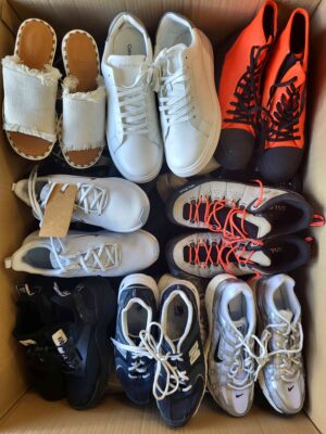 The photo shows a package with footwear in the category SH.