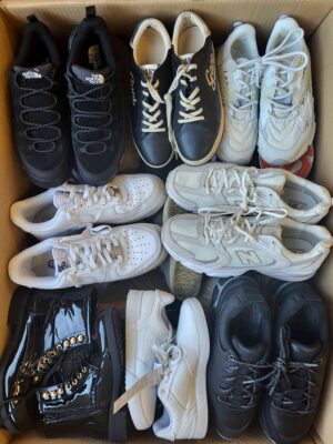The photo shows a package with footwear in the category SH.