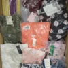 The photo shows a package with clothing in the category AW.